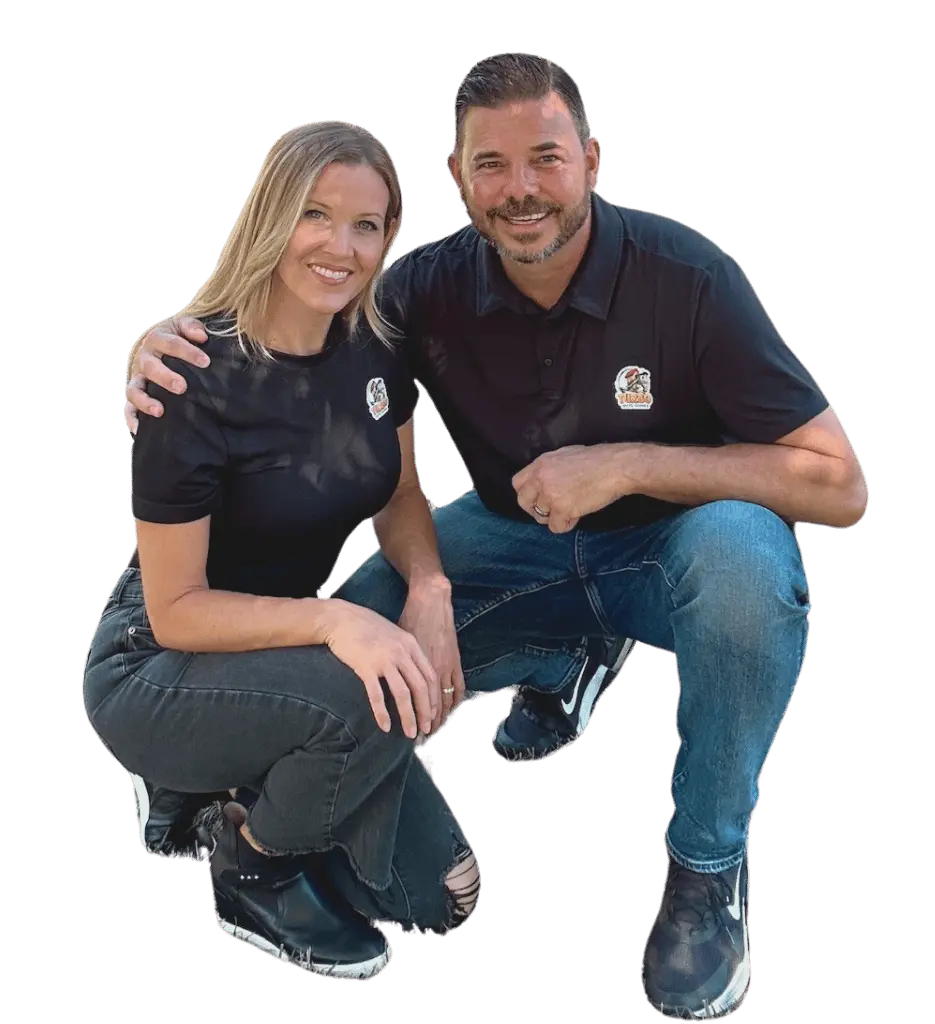 Laura and Brook, co-owners of Turbo Buys Homes, kneeling and engaged in front of a property they successfully helped purchase in Ventura, representing a trustworthy team specializing in 'we buy houses in Ventura.'